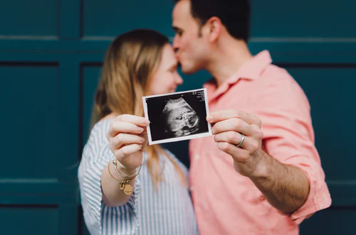 A couple holding a baby scan 